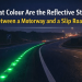 what colour are the reflective studs between a motorway and a slip road